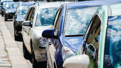 Row of cars lined up next to curb