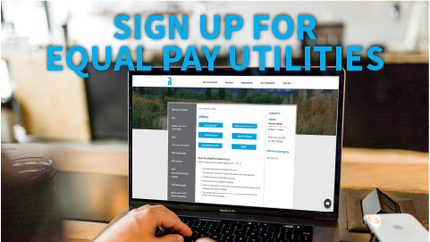 Laptop computer with hands typing on keyboard