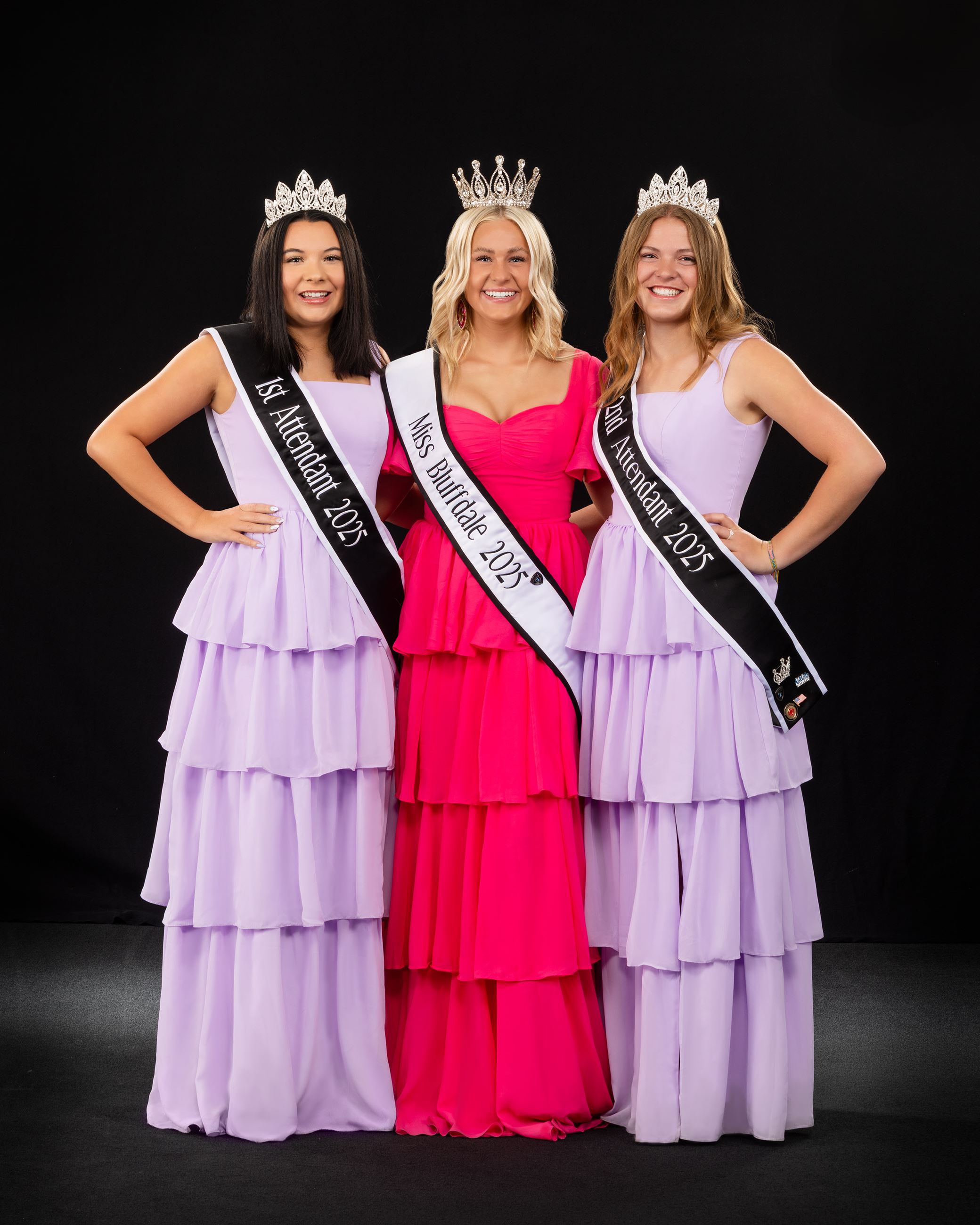 3 women in dresses with crowns and sashes