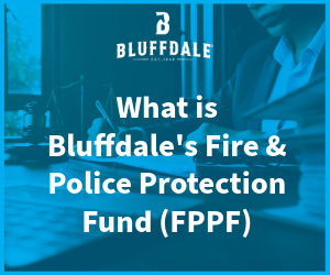 Close up of person at desk writing on stack of papers